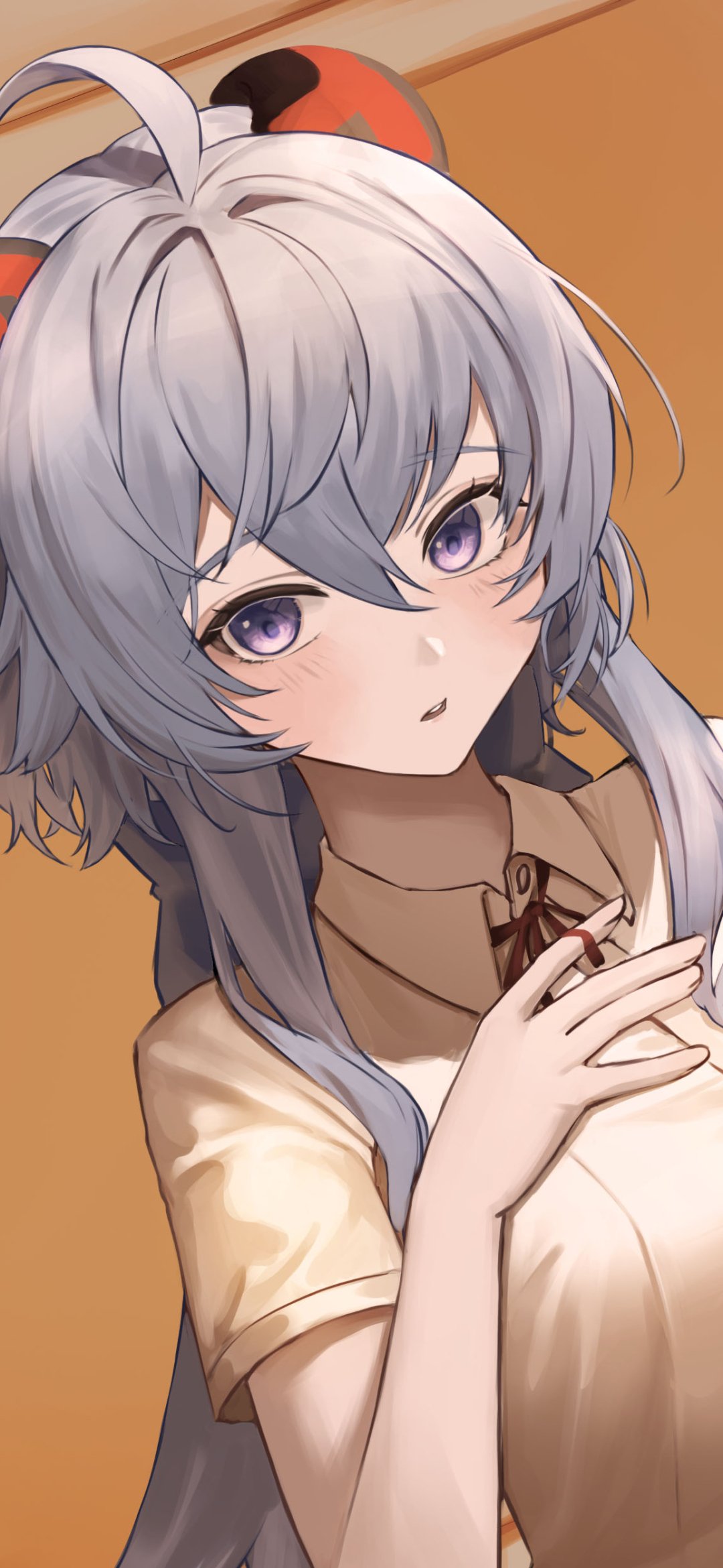 Phone wallpaper of Ganyu (Genshin Impact), video game character — close-up portrait with silver-blue hair, purple eyes and a gentle expression against a warm orange backdrop.