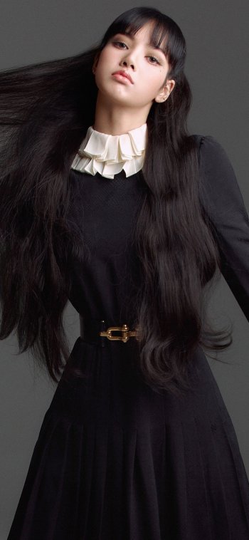 Music-themed phone wallpaper (iPhone/Android) tagged BlackPink: vertical portrait of a female pop artist in a black dress with white ruffled collar, long flowing hair against a gray backdrop.