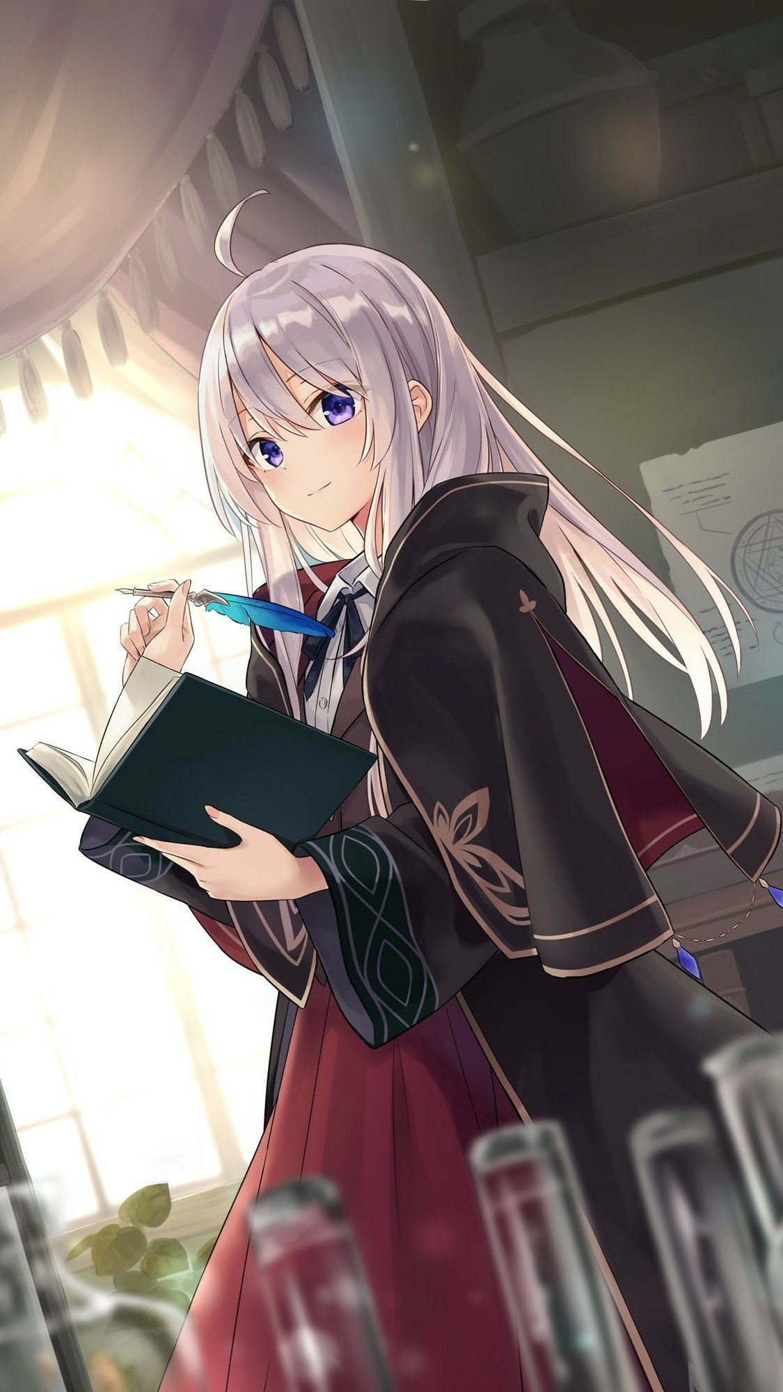 Phone wallpaper of Elaina from the anime Wandering Witch: The Journey of Elaina — a witch in a cloak writing in a book with a quill in a sunlit study.