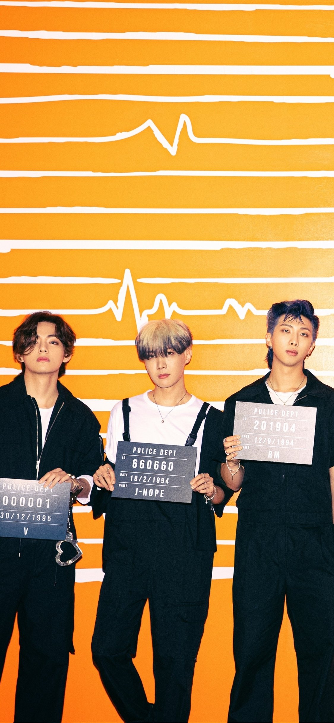 Phone wallpaper: music-themed shot of three young performers holding placard-style boards against a bright orange background with stylized heartbeat lines.