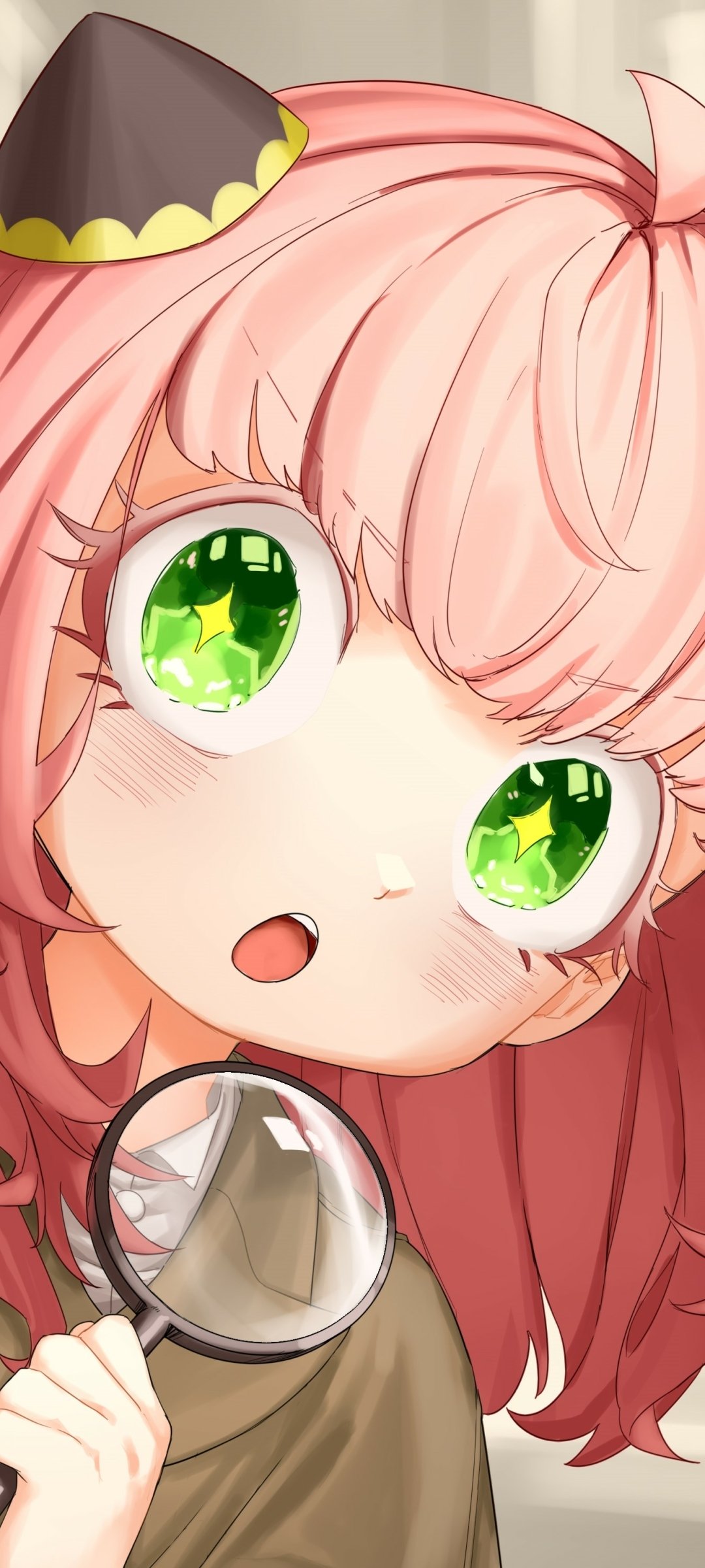 Anya Forger (Spy x Family) phone wallpaper — close-up anime portrait with pink hair, bright green eyes, tiny detective hat and a magnifying glass, for iPhone and Android.