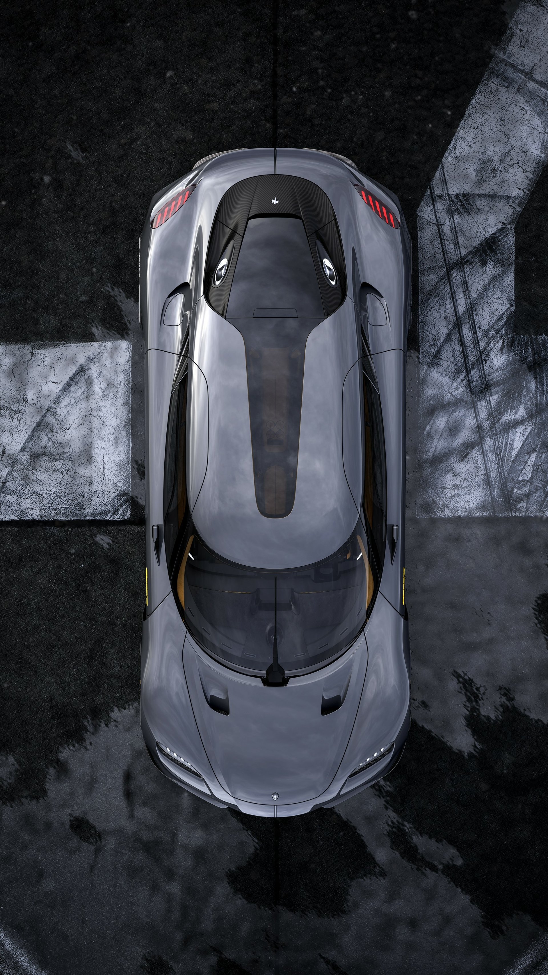A top-down view of a sleek Koenigsegg Gemera, showcasing its aerodynamic design against a textured dark background, making a striking phone wallpaper.